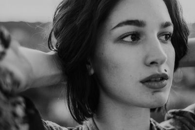 Close-up portrait of young woman looking away