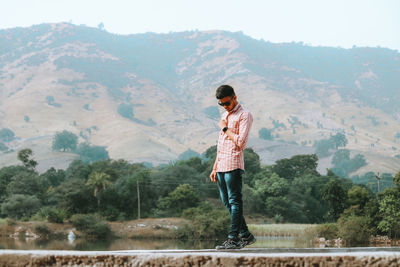 Full length of man standing on mountain