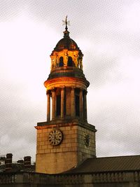 Low angle view of clock tower against sky