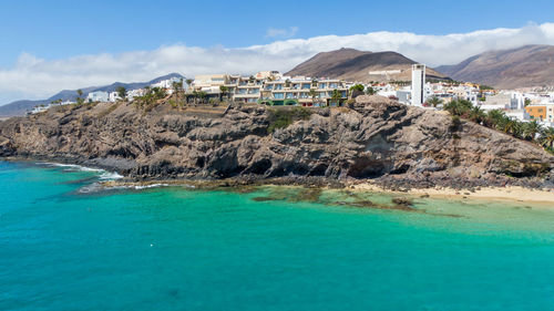 Scenic view of sea and buildings against sky