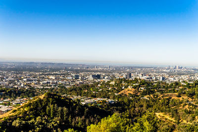 Aerial view of city buildings against clear sky