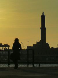 Silhouette people standing against sky at sunset