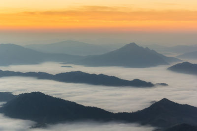 Scenic view of silhouette mountains against sky during sunset