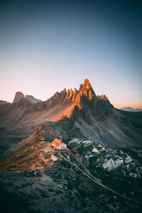 Scenic view of mountains against clear sky during sunset