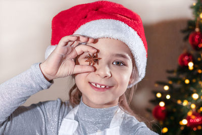 Portrait of young woman wearing santa hat