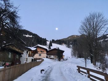 Snow covered houses and buildings against sky