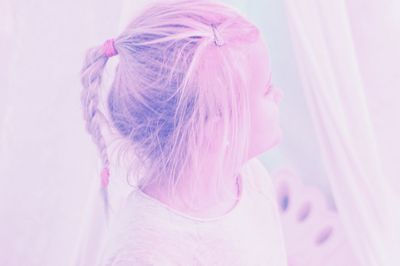 Portrait of woman with pink hair against white background