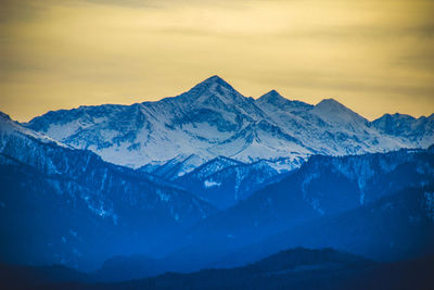 Mountain summit with snow in spring, winter , sunset