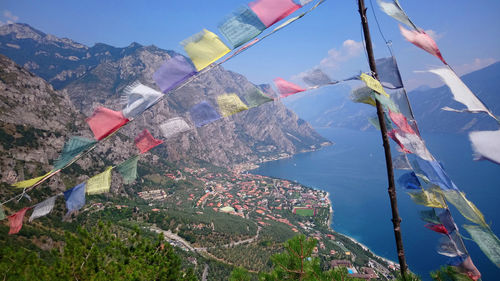 Panoramic view of flags and buildings against sky