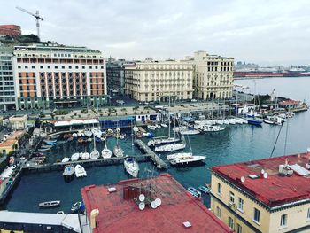 Boats in river with buildings in background