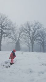Person walking on snow covered field
