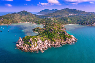 Aerial view of sea and mountains against sky