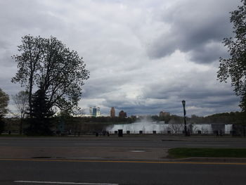 Road by city against sky