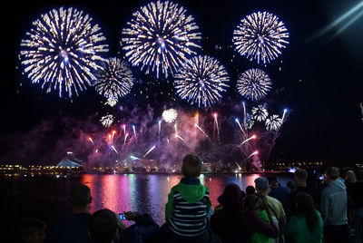 Low angle view of firework display at night