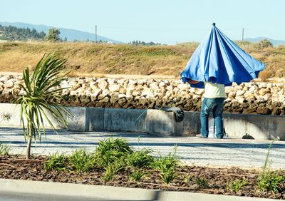 Rear view of woman walking on country road