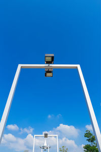 Low angle view of telephone pole against blue sky