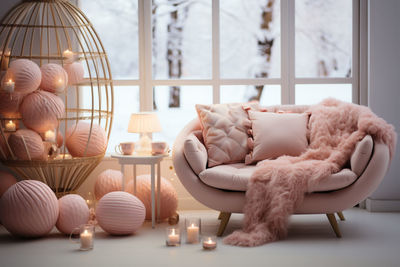 Close-up of woman sitting on sofa at home