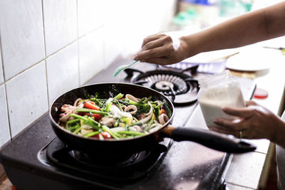 Midsection of man preparing food at home