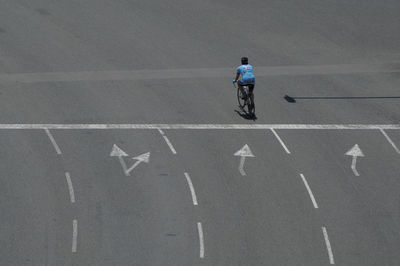 Man riding bicycle on road