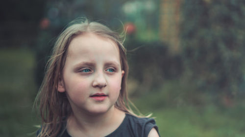 Close-up of cute girl looking away