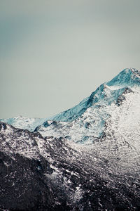 Scenic view of snowcapped mountains against clear sky