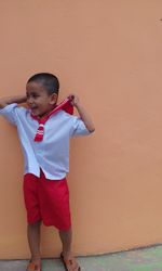 Boy standing against wall