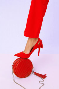 Fashion unrecognizable lady in retro red pants and shoes. studio lookbook. trends 