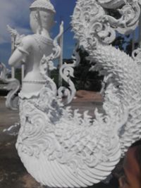 Close-up of sculpture against sky