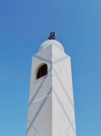 Low angle view of building against clear blue sky