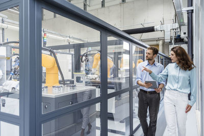 Businessman and woman having a meeting in high tech company