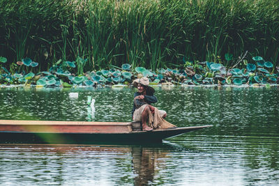 Woman sitting on boat in lake