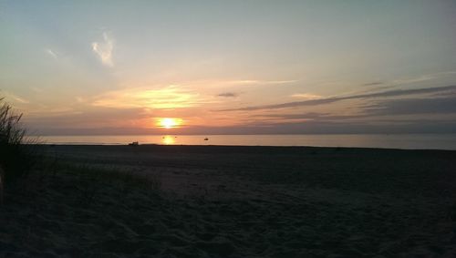 Scenic view of beach against sky during sunset