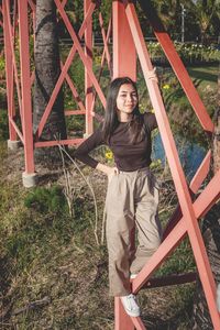 Portrait of smiling young woman standing on playground