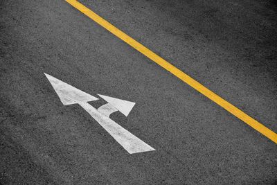 High angle view of arrow sign on road