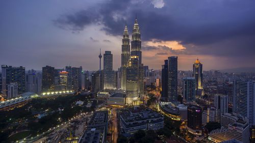 High angle view of city lit up at night