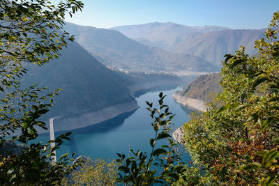 Scenic view of lake and mountains against sky