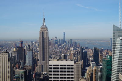 Aerial view of cityscape against blue sky