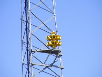 Low angle view of air raid siren against clear blue sky