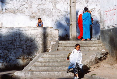 Full length of young man standing on wall