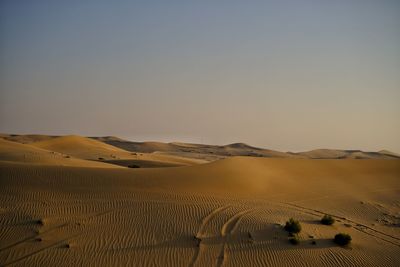 Scenic view of desert against sky during sunset