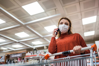 Low angle view of woman holding umbrella