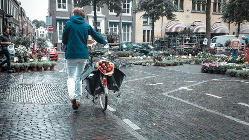Woman with umbrella on street in rainy season