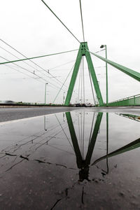 Reflection of electricity pylon against sky