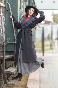 Portrait of young woman standing in factory