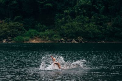 Woman swimming in river.