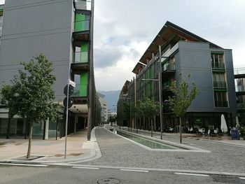 Empty road along buildings