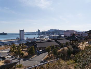 High angle view of buildings and sea against sky