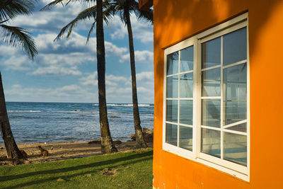 Scenic view of sea against sky seen through window