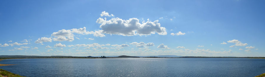 Panoramic view of sea against blue sky