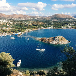 High angle view of boat moving on sea against mountain